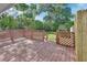 View of the back wooden deck facing the treed and fenced backyard at 532 W Wisconsin Ave, Deland, FL 32720