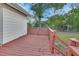 View of the back wooden deck with the lawn and trees in the background at 532 W Wisconsin Ave, Deland, FL 32720