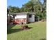 Landscaped backyard featuring a wooden deck, well maintained lawn and surrounding trees at 532 W Wisconsin Ave, Deland, FL 32720