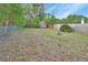 Wide shot of a treed and fenced backyard with a shed and lawn area at 532 W Wisconsin Ave, Deland, FL 32720
