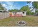 Backyard showcasing a wooden deck, a fire pit, and a spacious, fenced yard at 532 W Wisconsin Ave, Deland, FL 32720