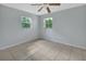 The empty bedroom has two windows and tile floors at 532 W Wisconsin Ave, Deland, FL 32720