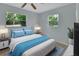 Cozy bedroom with two windows, tile floors, and neutral paint at 532 W Wisconsin Ave, Deland, FL 32720