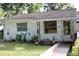 Charming single-story home with a well-maintained lawn and mature trees at 532 W Wisconsin Ave, Deland, FL 32720