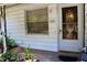 Close-up of home's front porch shows the front door with sidelight and house number at 532 W Wisconsin Ave, Deland, FL 32720