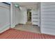 A covered patio area with white columns, a white door, and a wooden deck at 532 W Wisconsin Ave, Deland, FL 32720