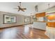 Bright and spacious living room with laminate floors and kitchen access at 113 Amberglow Ct, Debary, FL 32713