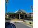 Community clubhouse featuring a unique roof design and well-maintained landscaping at 600 N Boundary Ave # 106D, Deland, FL 32720