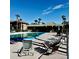 Community pool area with lounge chairs and lush palm trees in the background on a sunny day at 600 N Boundary Ave # 106D, Deland, FL 32720