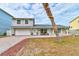 Single-Gathering home with gray siding and a white garage door at 4766 S Atlantic Ave, Ponce Inlet, FL 32127