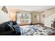 Bright living room with hardwood floors and a nautical-themed rug at 4766 S Atlantic Ave, Ponce Inlet, FL 32127