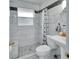 Updated bathroom with marble-look tile and a walk-in shower at 714 E Michigan Ave, Deland, FL 32724