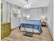 Comfortable bedroom with light wood flooring and neutral walls, with bright, natural light at 714 E Michigan Ave, Deland, FL 32724