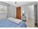 Bright bedroom featuring a bed, wood closet doors, and an adjacent doorway at 714 E Michigan Ave, Deland, FL 32724