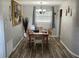 Bright dining room featuring modern chandelier, light-colored flooring and a large picture at 714 E Michigan Ave, Deland, FL 32724