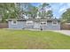 Well-maintained single-story home with a green lawn and quaint front porch at 714 E Michigan Ave, Deland, FL 32724