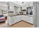 Cozy kitchen with updated white cabinets and a microwave at 714 E Michigan Ave, Deland, FL 32724
