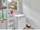 Bright laundry area with a dryer, shelving, window and supplies at 714 E Michigan Ave, Deland, FL 32724