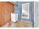 Laundry room with stone floors, wood accent wall and laundry appliance at 714 E Michigan Ave, Deland, FL 32724