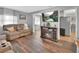 Inviting living room with wood floors, comfortable seating, and a modern electric fireplace at 714 E Michigan Ave, Deland, FL 32724