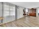 Charming living room with wood-look flooring, a china cabinet, and large bright windows at 714 E Michigan Ave, Deland, FL 32724