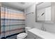 Updated bathroom features a new vanity, framed mirror, and stylish shower curtain, a clean and modern design at 1640 Juno Trl # 205A, Astor, FL 32102