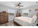 Cozy bedroom features wood-look floors, two windows, ceiling fan and neutral paint, creating a peaceful retreat at 1640 Juno Trl # 205A, Astor, FL 32102