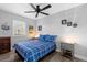 This bedroom features a bed with a blue plaid comforter and white walls with accent decor at 1640 Juno Trl # 205A, Astor, FL 32102