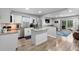 Bright kitchen with granite countertops, a center island, stainless steel appliances, and wood-look flooring at 1640 Juno Trl # 205A, Astor, FL 32102