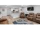 Spacious living room with wood floors, comfortable seating, and direct access to the modern kitchen at 1640 Juno Trl # 205A, Astor, FL 32102