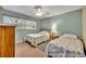 Guest bedroom with two twin beds and ceiling fan at 4430 Doris Dr, New Smyrna Beach, FL 32169