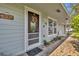Inviting front porch with brick pavers, potted plants, and a charming door at 4430 Doris Dr, New Smyrna Beach, FL 32169