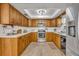 Bright kitchen with stainless steel appliances and light wood cabinets at 4430 Doris Dr, New Smyrna Beach, FL 32169