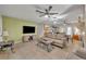 Open living room and kitchen with wood-look floors and ceiling fans at 4430 Doris Dr, New Smyrna Beach, FL 32169