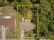 Aerial view showcasing a backyard surrounded by lush greenery and mature trees at 1639 Templewood Ave, Deltona, FL 32725