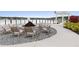Lakefront fire pit with seating and pergola at 168 Azure Ct, Daytona Beach, FL 32124