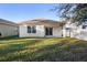 Spacious backyard with a covered patio and lush lawn at 2924 Taton Trce, New Smyrna Beach, FL 32168