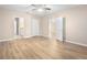 Large bedroom with wood-look floors and access to bathroom at 2924 Taton Trce, New Smyrna Beach, FL 32168