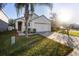 House exterior showcasing a well-manicured lawn and driveway at 2924 Taton Trce, New Smyrna Beach, FL 32168