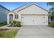 Home exterior with a two-car garage, manicured landscaping, and a lovely facade at 2924 Taton Trce, New Smyrna Beach, FL 32168