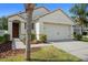 Charming home exterior featuring a two-car garage, well-maintained landscaping, and a welcoming entrance at 2924 Taton Trce, New Smyrna Beach, FL 32168