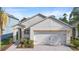 Attractive home exterior featuring a two-car garage, neat landscaping, and a welcoming entrance area at 2924 Taton Trce, New Smyrna Beach, FL 32168