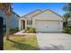 Beautiful home exterior with a two-car garage, inviting entryway, and well-kept front yard at 2924 Taton Trce, New Smyrna Beach, FL 32168