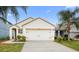 Charming single-story home with a two-car garage, lush landscaping, and a well-manicured lawn at 2924 Taton Trce, New Smyrna Beach, FL 32168