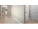 Neutral-toned hallway featuring light-colored tile flooring and white doors leading to other rooms at 2924 Taton Trce, New Smyrna Beach, FL 32168