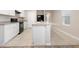 Kitchen island with white cabinets and a breakfast bar at 2924 Taton Trce, New Smyrna Beach, FL 32168