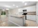 Bright kitchen with island, white cabinets, and stainless steel appliances at 2924 Taton Trce, New Smyrna Beach, FL 32168