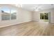 Living room with vinyl plank floors and sliding glass doors at 2924 Taton Trce, New Smyrna Beach, FL 32168