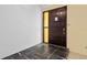 Solid wood front door with side window and slate tile flooring in the entryway of the home at 3019 John Anderson Dr, Ormond Beach, FL 32176