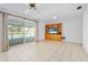 Bright living room with tile floors, a ceiling fan, and views of the backyard pool at 3019 John Anderson Dr, Ormond Beach, FL 32176